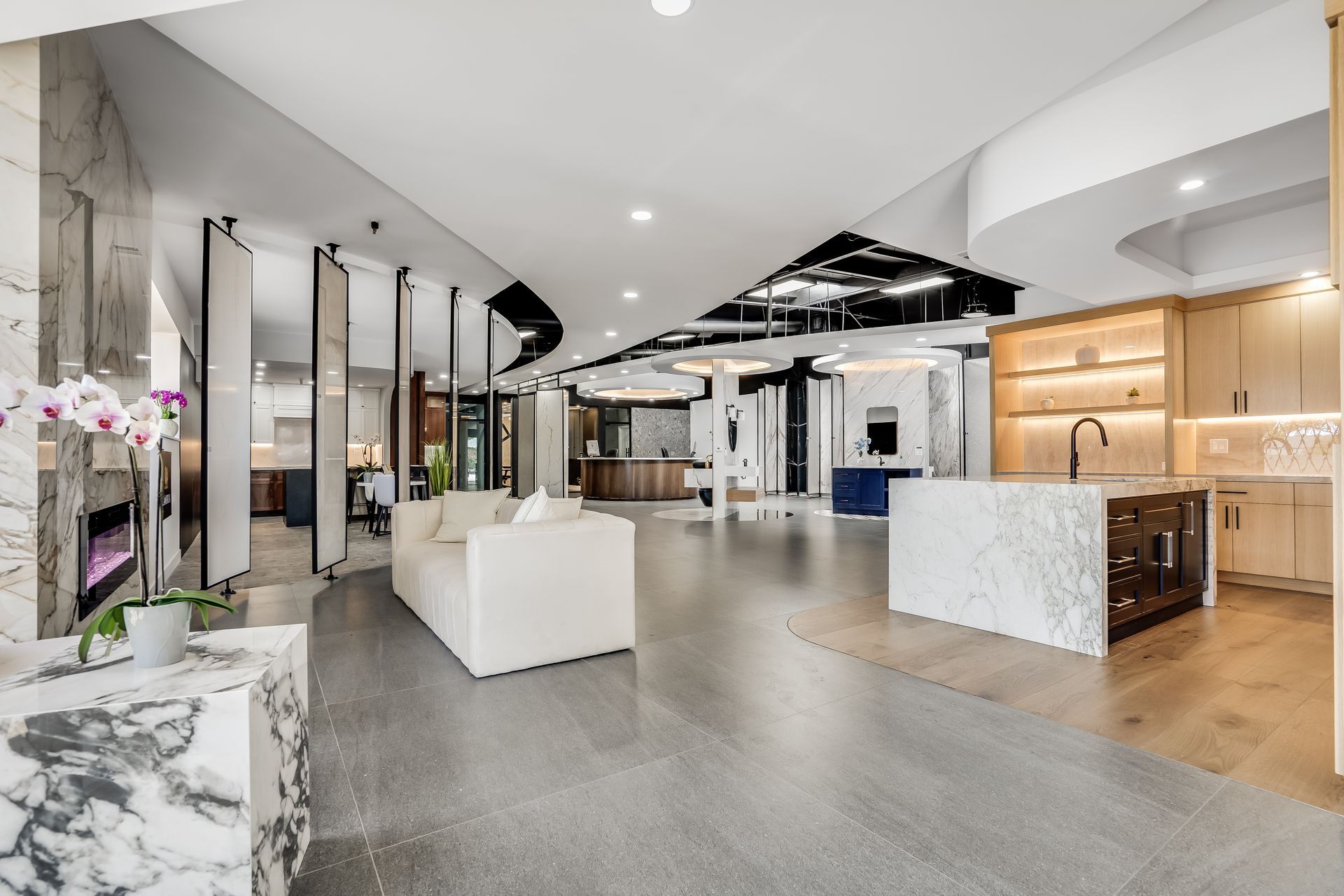 Modern spa lobby with white seating, marble counters, and warm wood accents