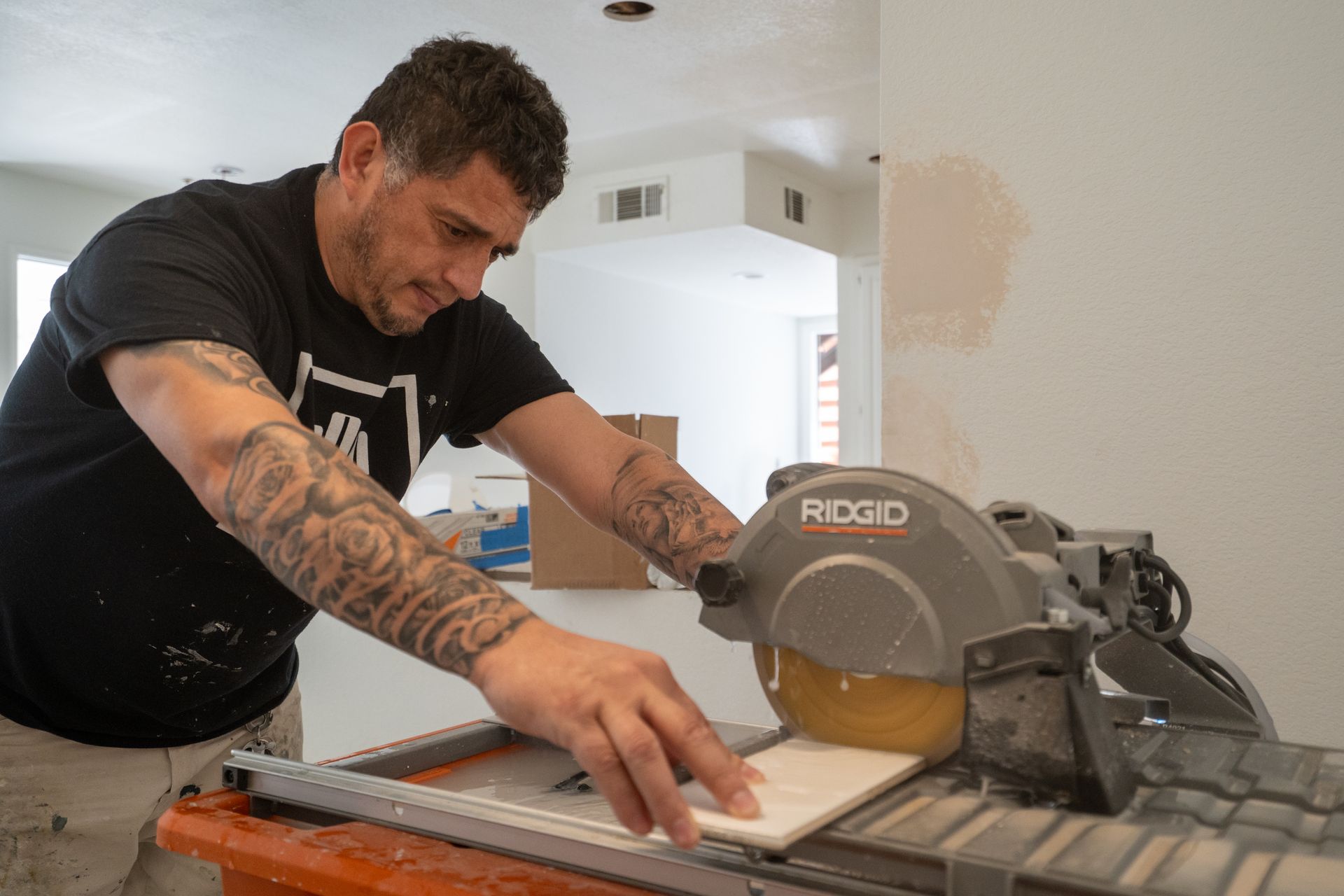Man using a circular saw to cut a board in a room under renovation