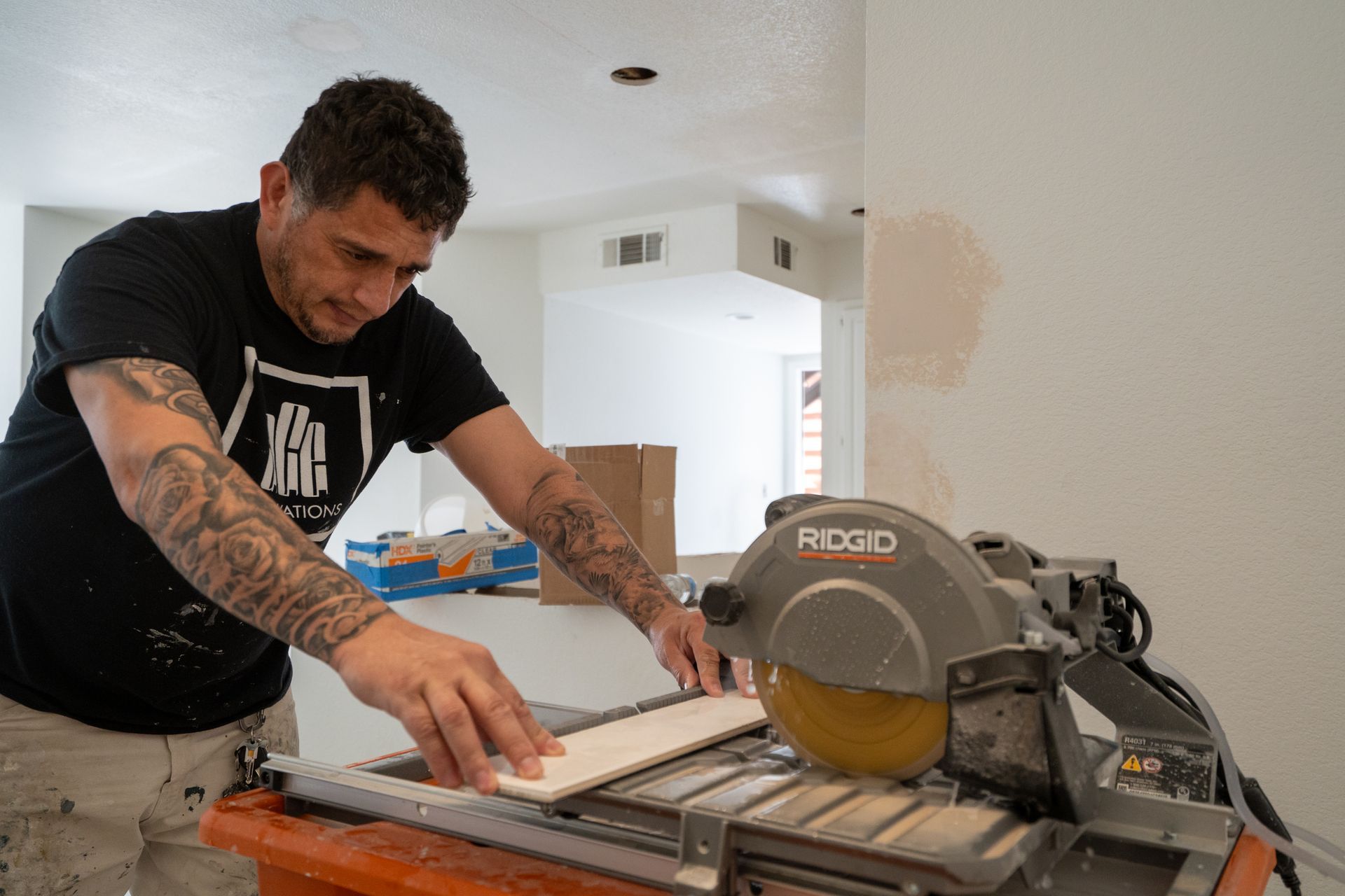 Man cutting wood with a circular saw on a workbench in a home renovation setting