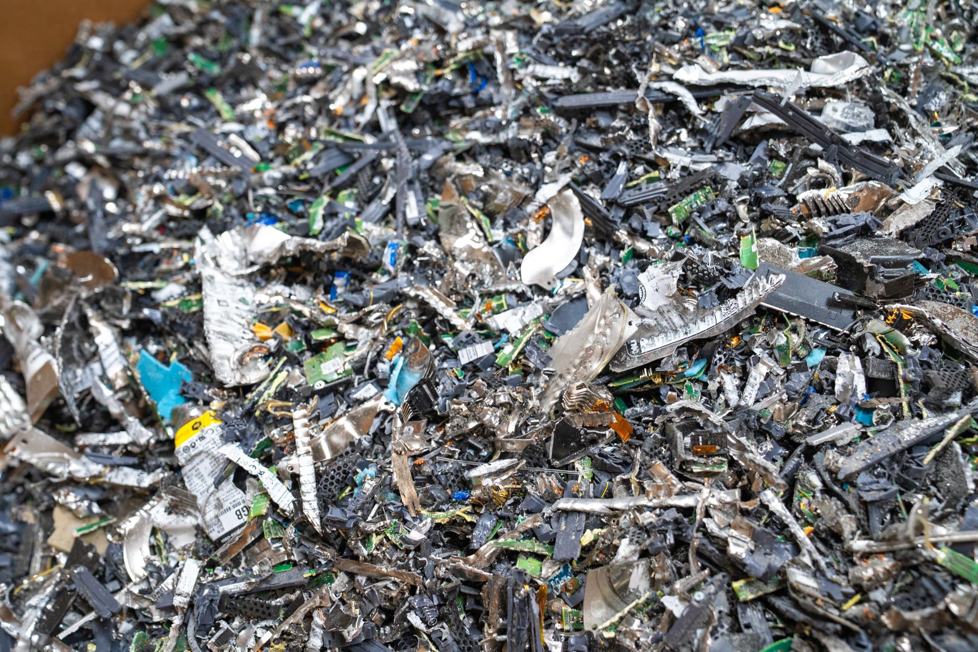 Pile of shredded circuit board components in varying colors.