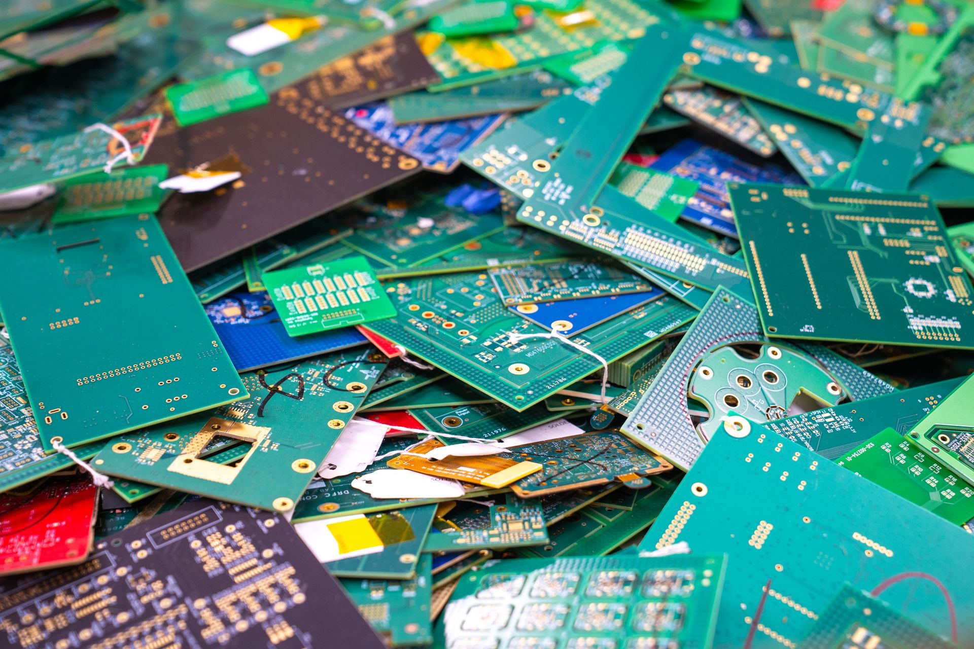Pile of discarded green circuit boards.
