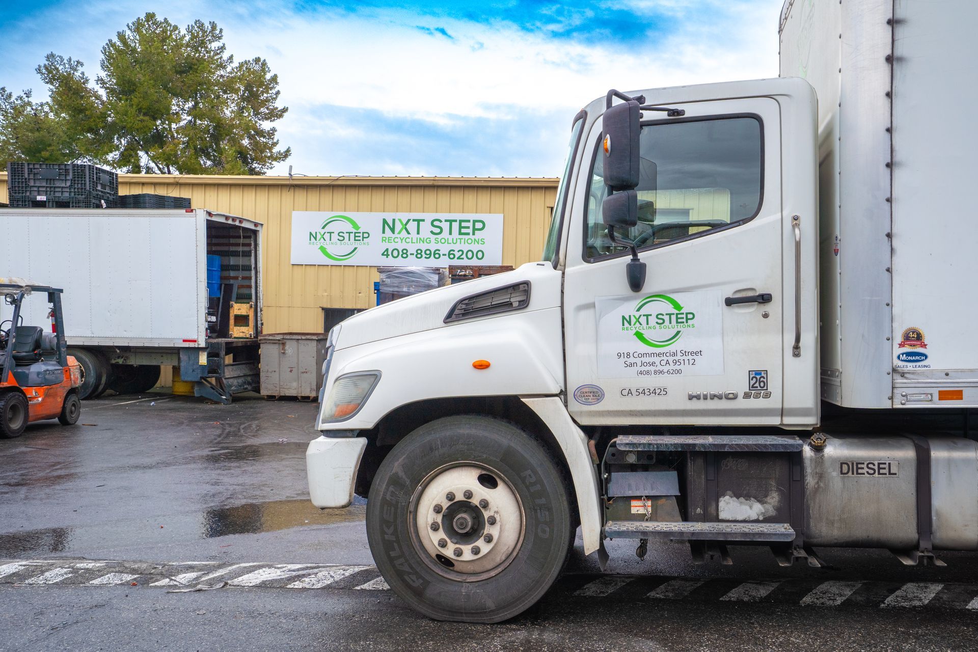White truck parked in front of a building with 