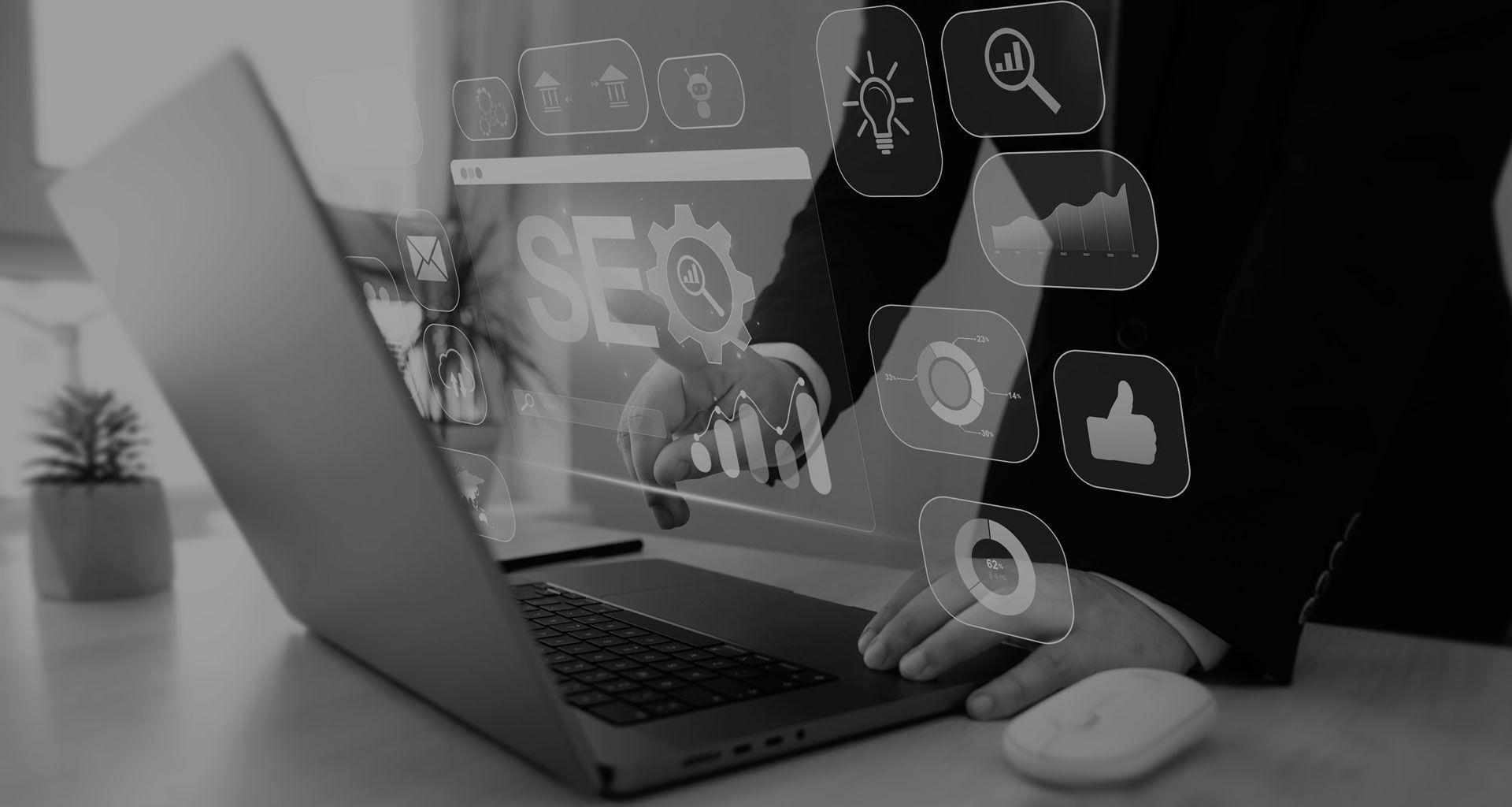 Person typing on a laptop with floating digital icons, including a lock and thumbs-up, on a desk.