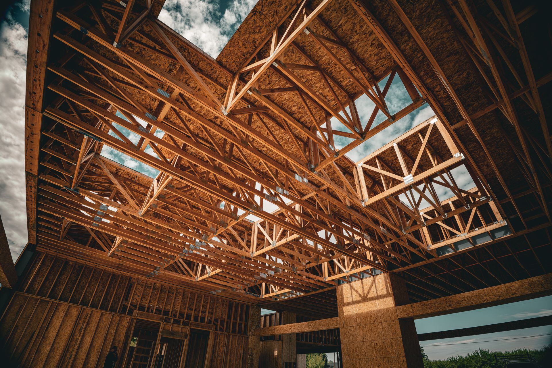 Wooden roof trusses and skylights in a timber-framed building under construction