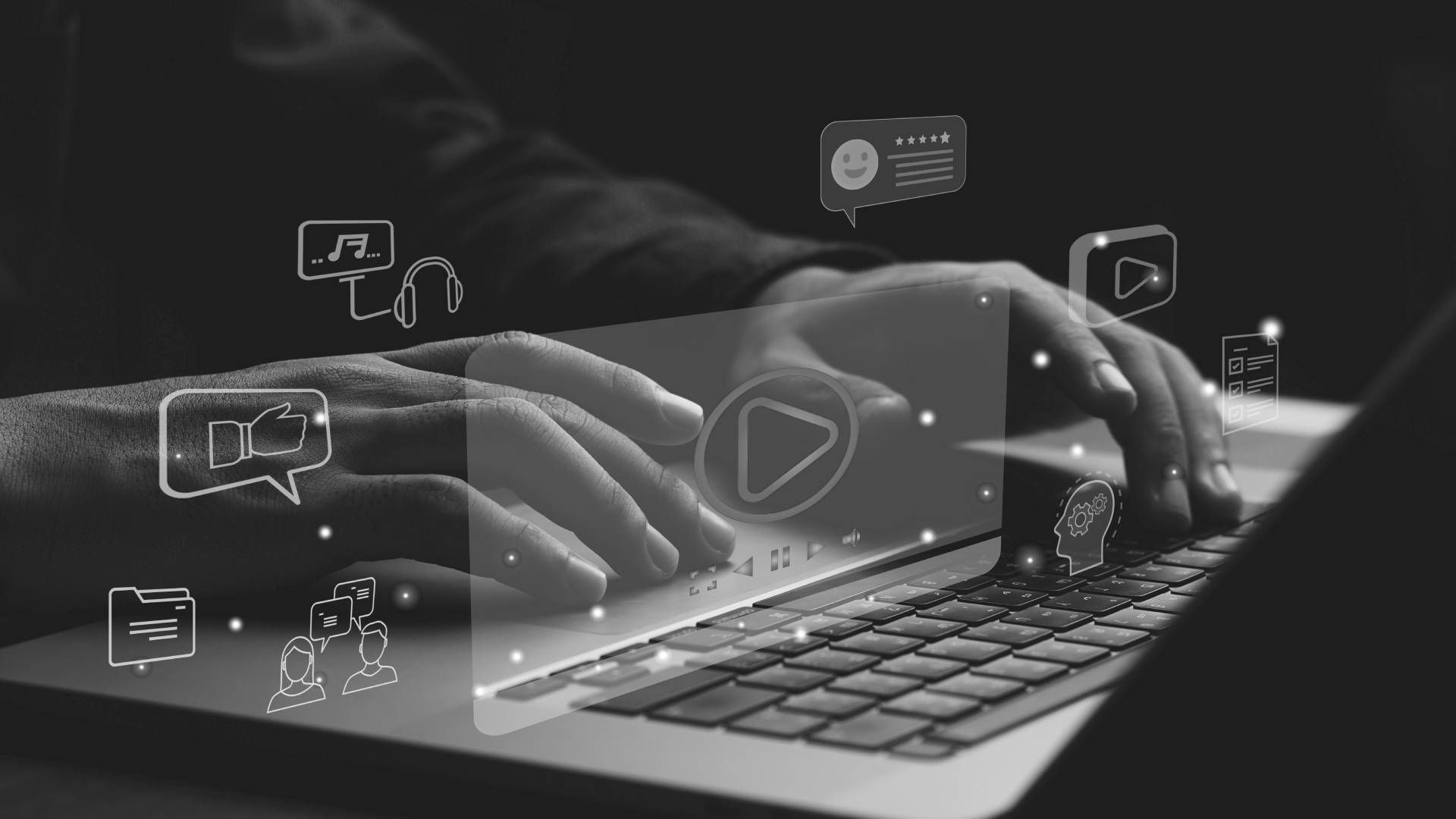 A person is typing on a laptop computer in a black and white photo.