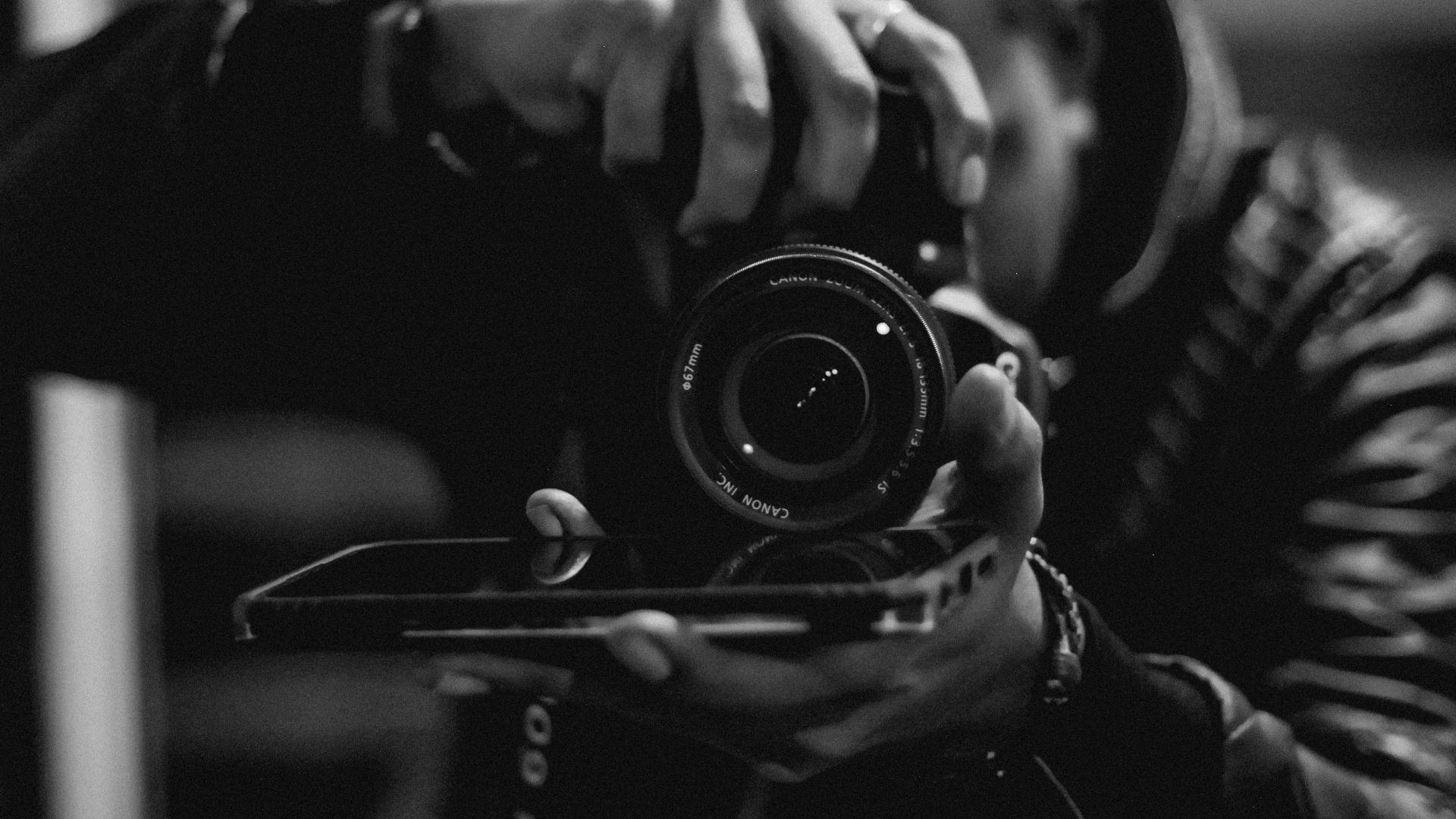 A man is taking a picture of himself with a camera.
