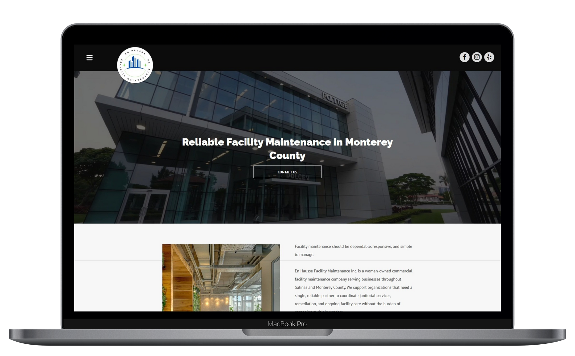 Laptop displaying a website homepage with a large building photo and text overlay