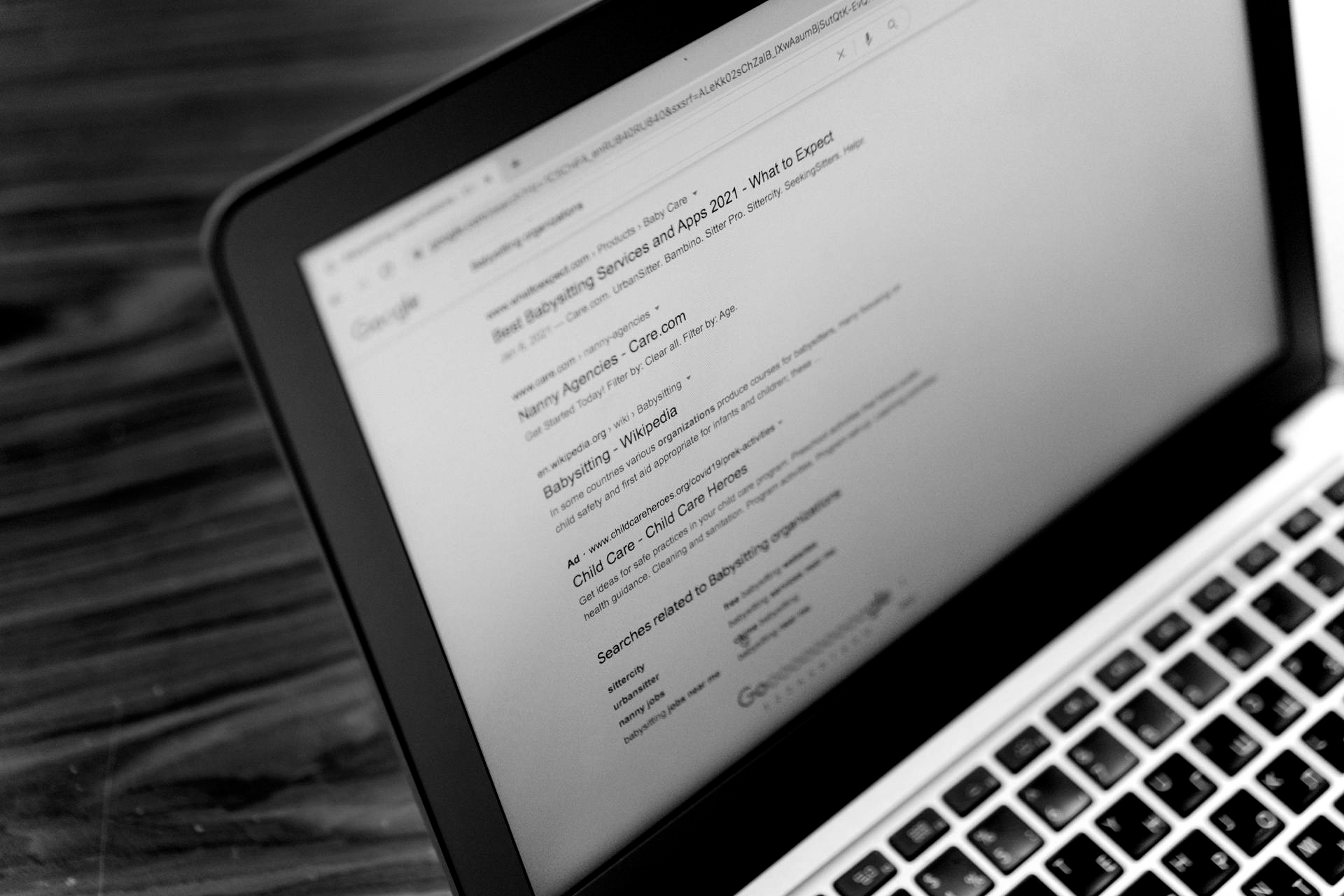 Hands typing on laptop with