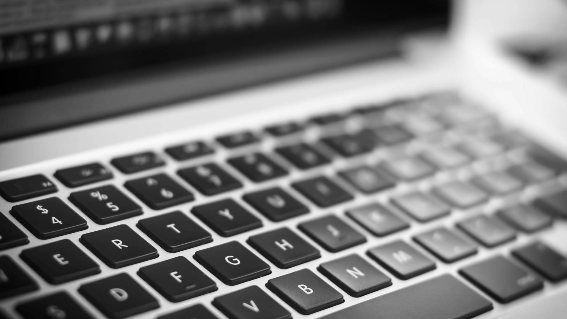 A black and white photo of a laptop keyboard