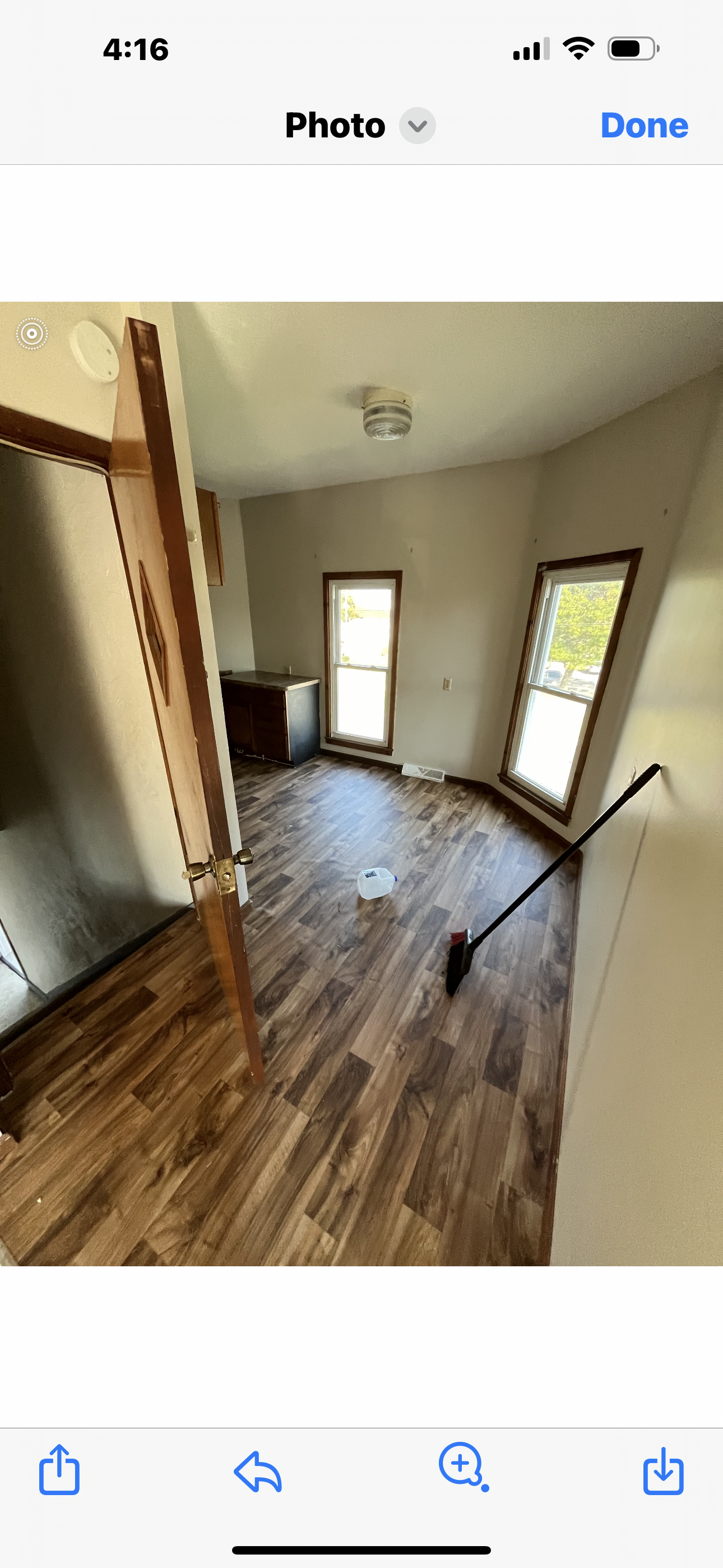 Samples of wooden flooring in various colors, arranged on a hardwood floor.