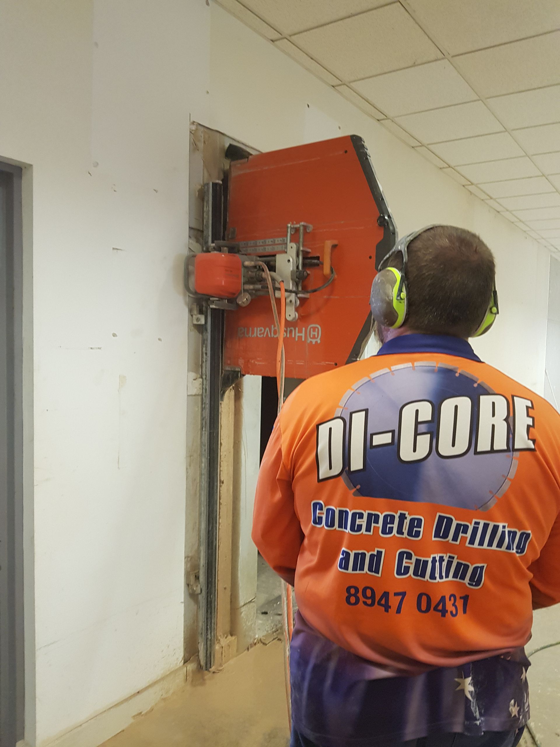 A Man is Cutting a Hole in a Wall With a Saw — Di-Core Drilling and Cutting in Katherine, NT