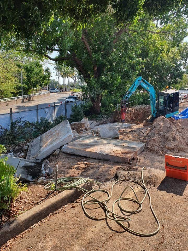 A Construction Site With a Blue Excavator and a Hose — Di-Core Drilling and Cutting in Darwin, NT