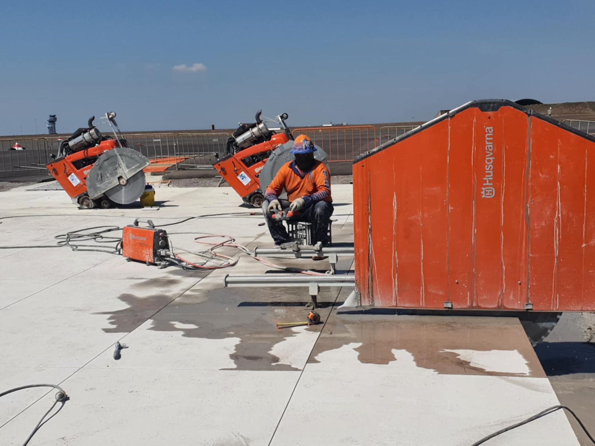 Construction site with two white trucks labeled 