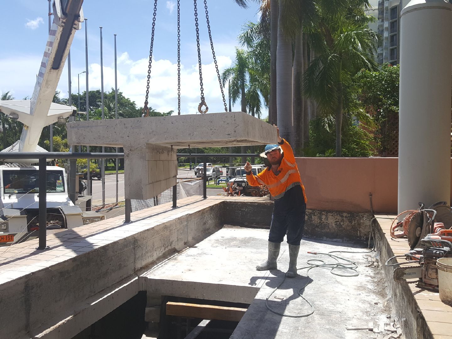 Construction worker guides a concrete beam being lifted by a crane into a trench — Di-Core Drilling and Cutting in Darwin, NT