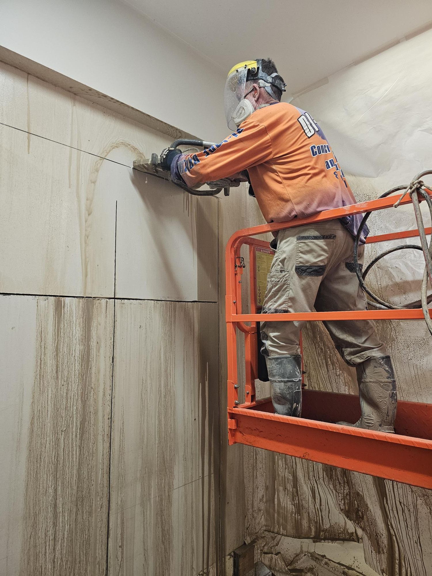 A Man is Cutting a Hole in a Wall With a Saw — Di-Core Drilling and Cutting in Darwin, NT