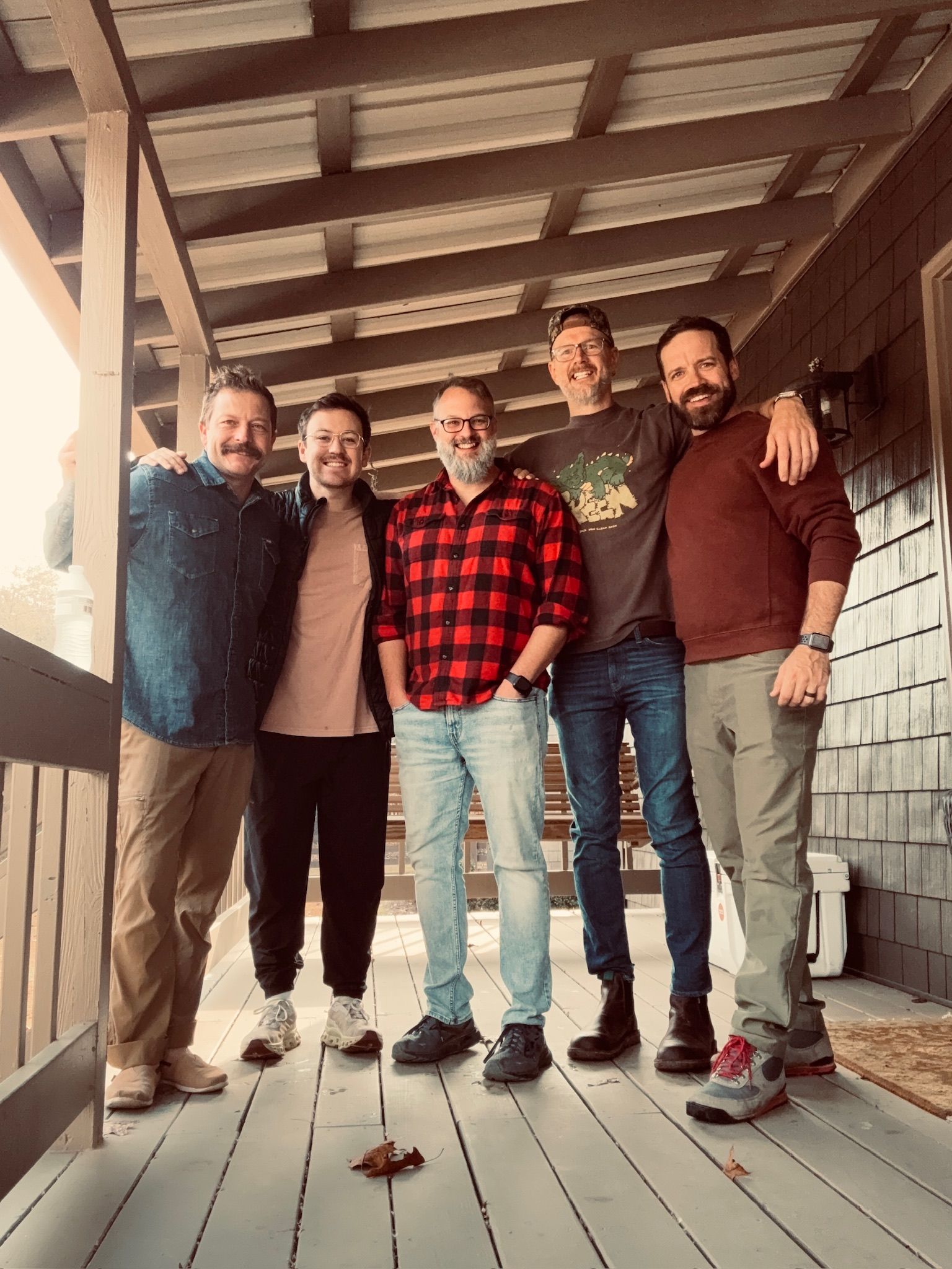 Five ministry leaders standing together on a Grace Valley cottage porch.