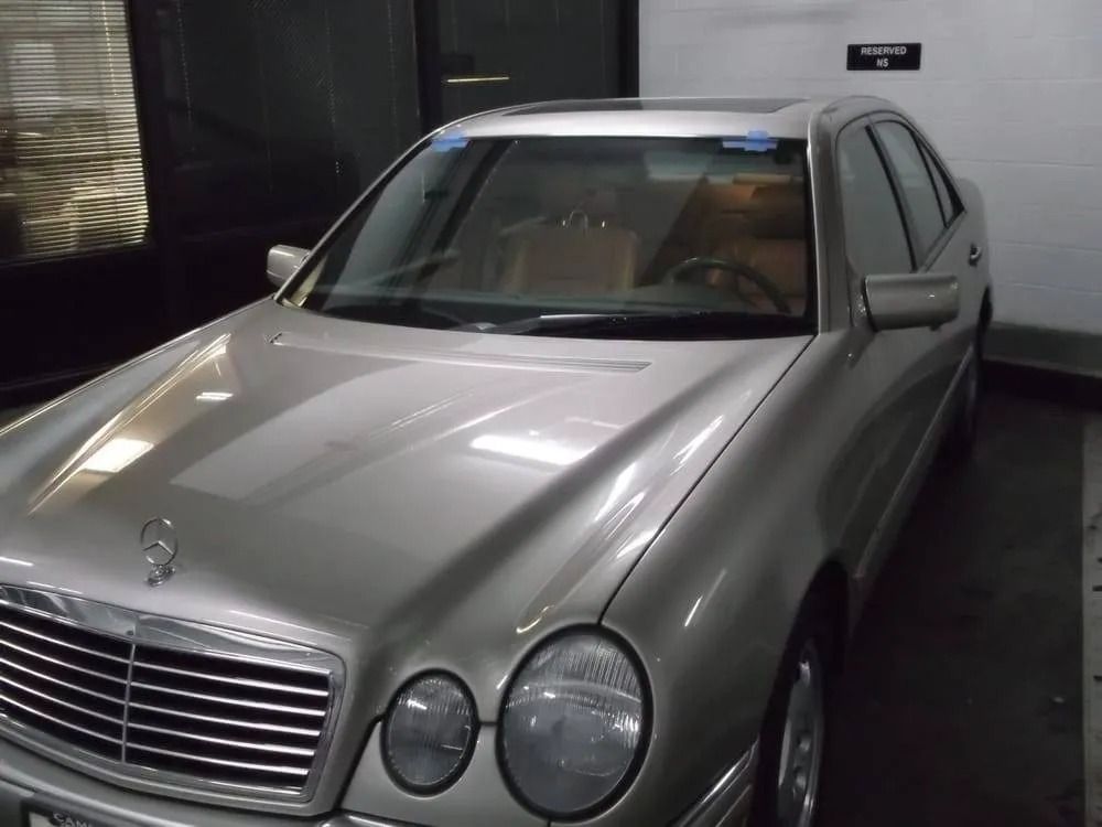 Silver Mercedes-Benz sedan parked in an indoor garage.