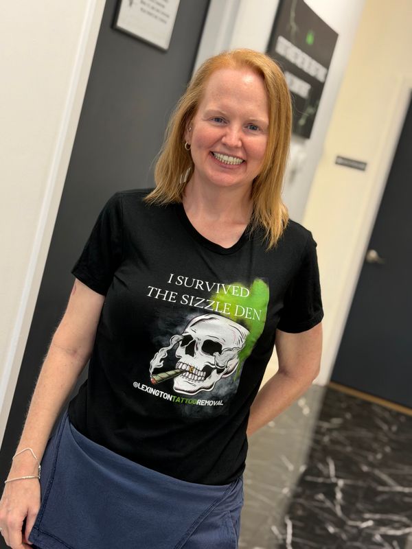 A woman wearing a black t-shirt with a skull on it