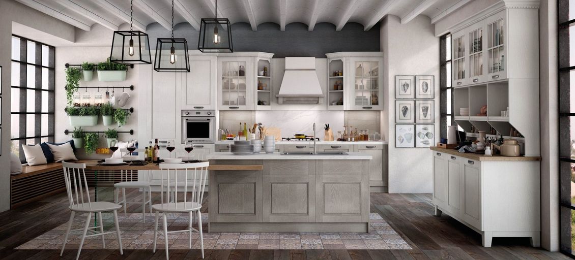 Una cucina con mobili bianchi e una grande isola al centro.