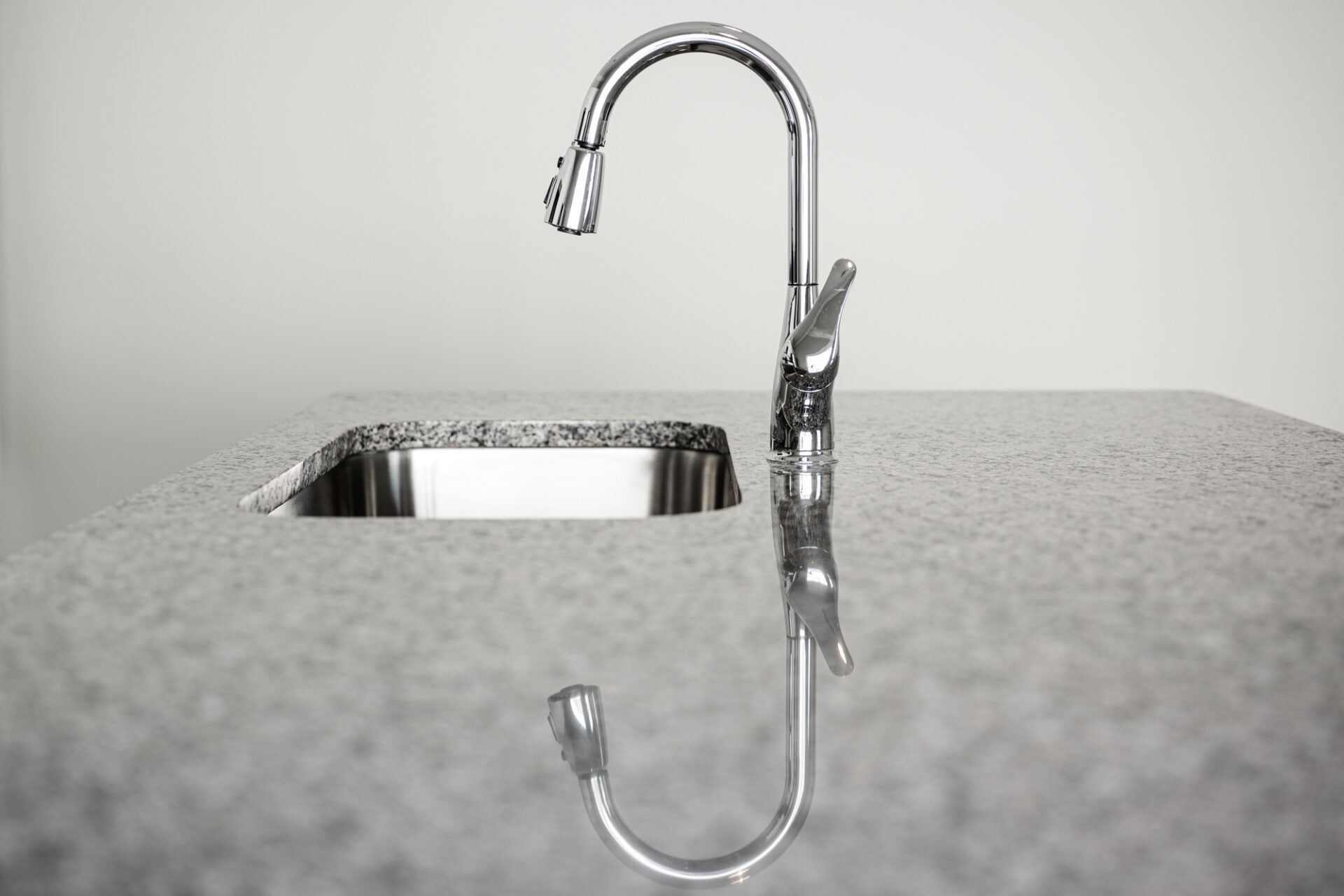A kitchen sink with a chrome faucet on a granite counter top  at Ashford Villas in Chattanooga, TN.