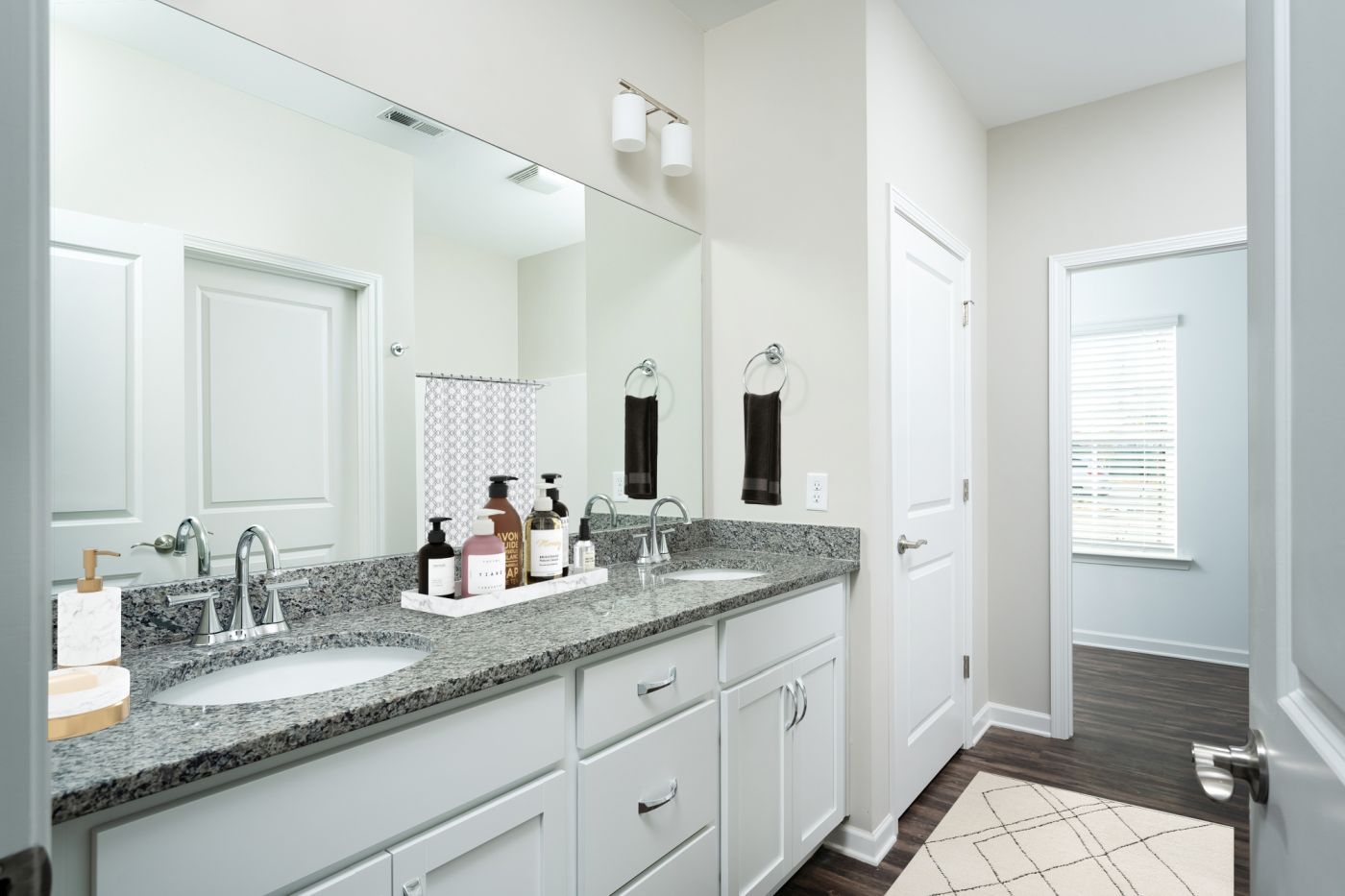 A bathroom with two sinks and a large mirror  at Ashford Villas in Chattanooga, TN.