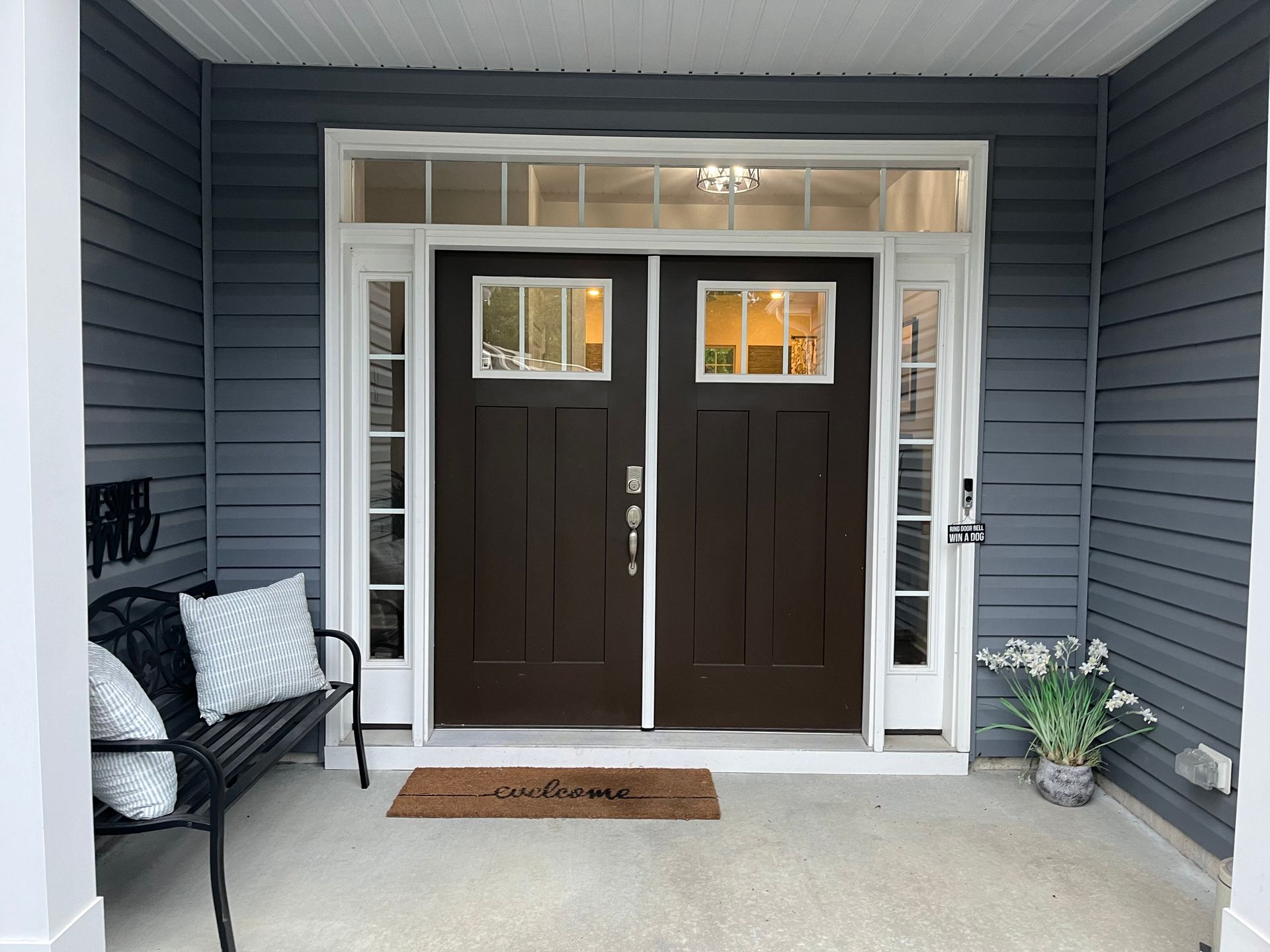 A brown door with a welcome mat in front of it