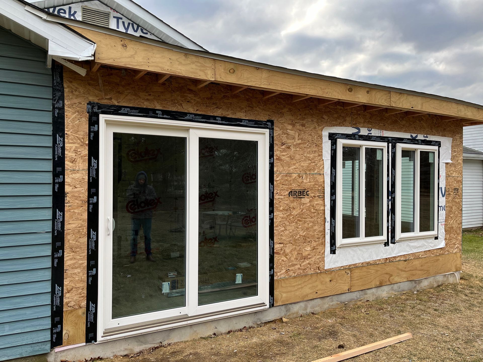 A house with a lot of windows is being built.