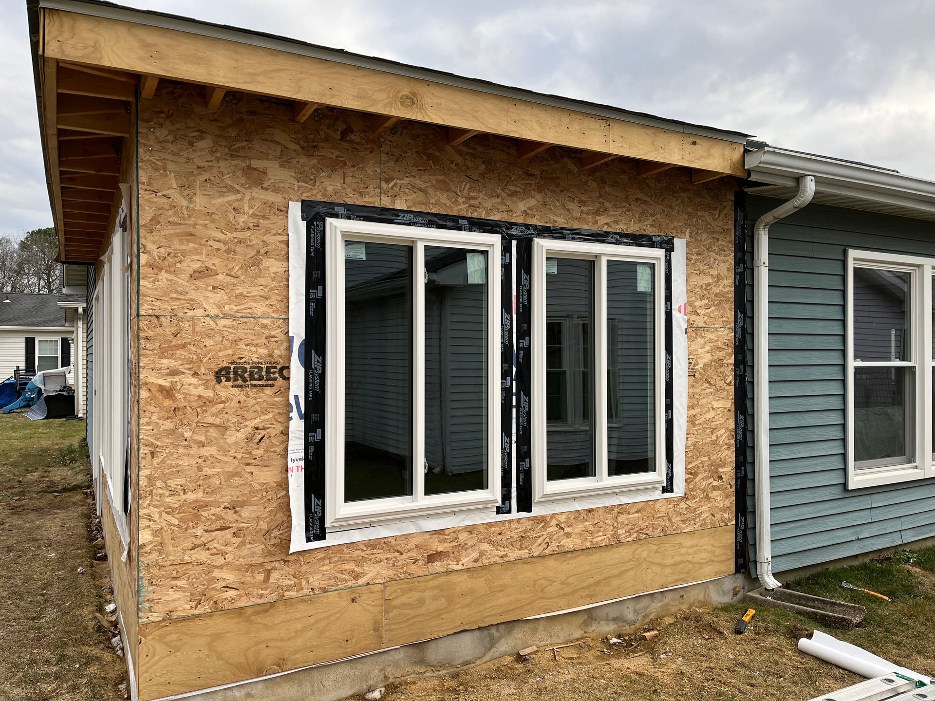 A house with a lot of windows is being built.