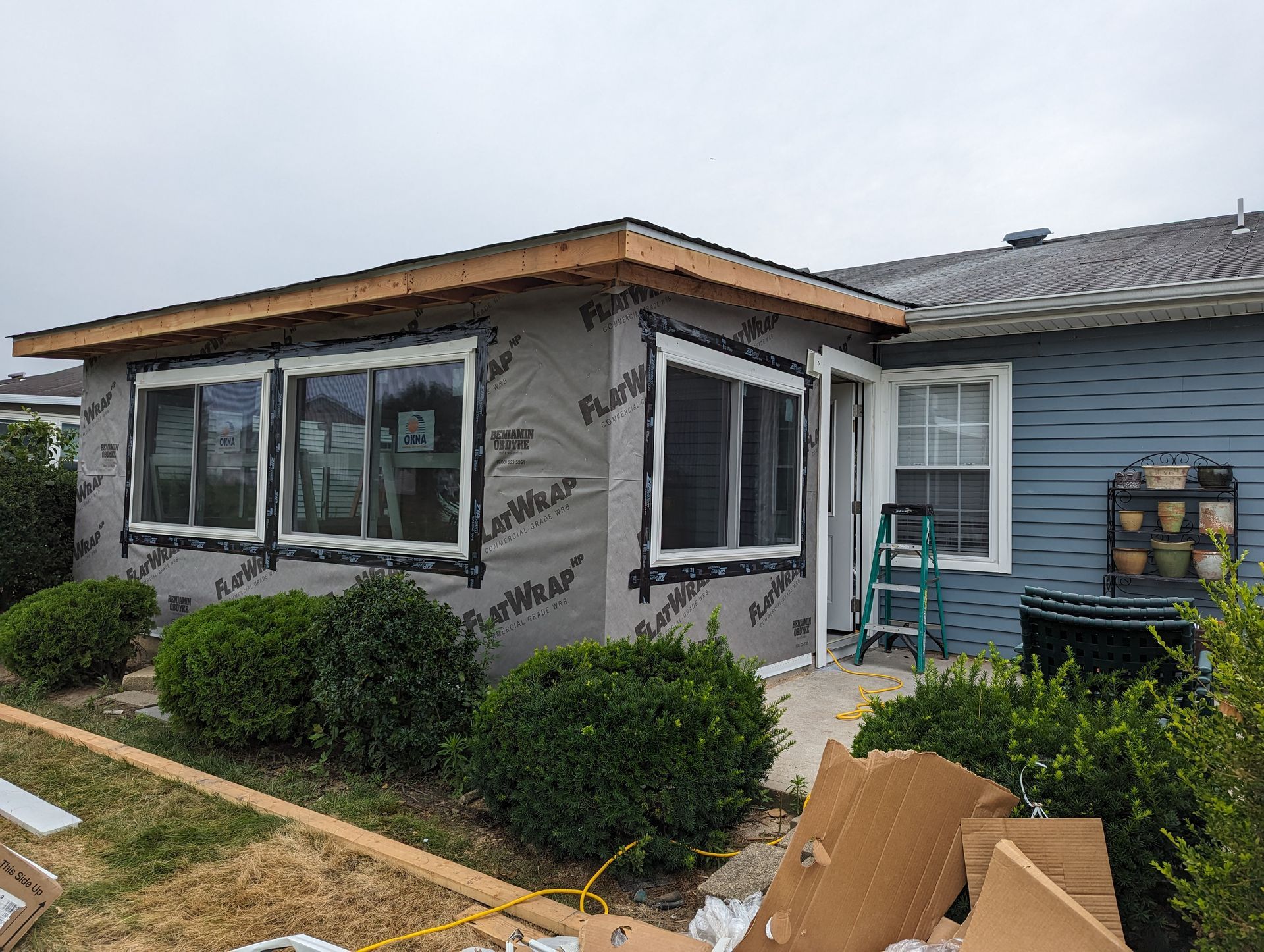 A house with a lot of windows is being remodeled.