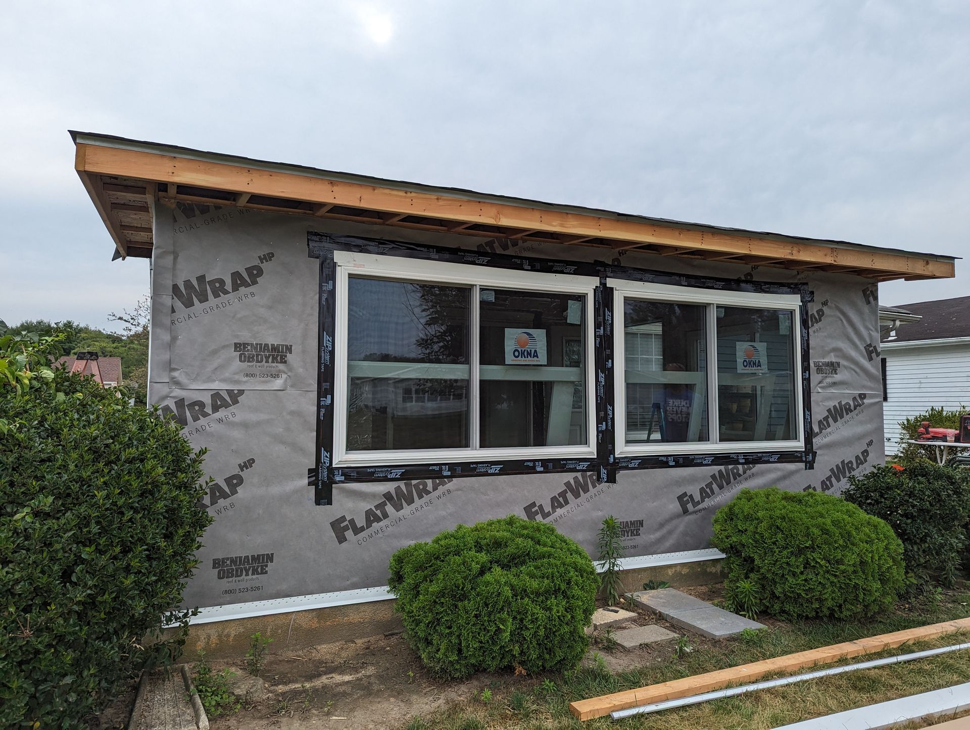 A house with a lot of windows is being built.