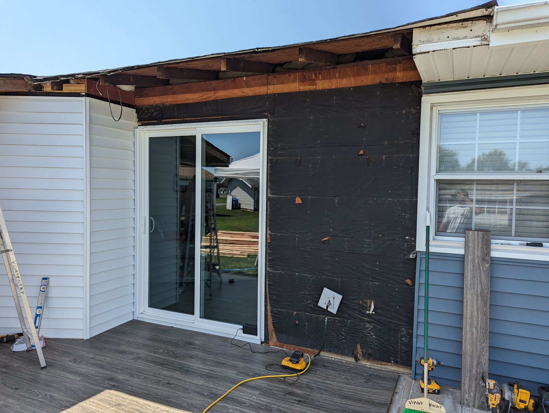 A house with a sliding glass door is being remodeled.