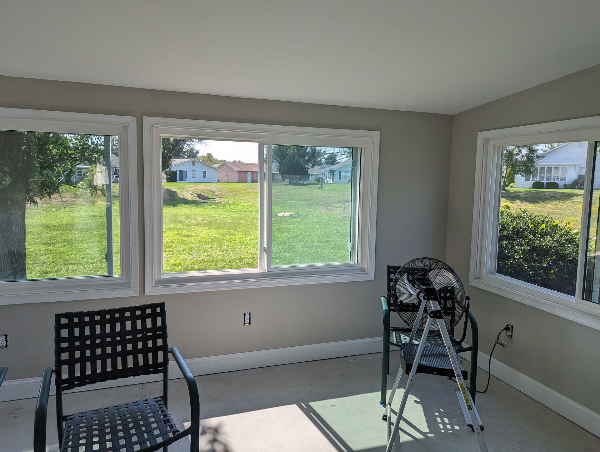A room with two chairs and a high chair in it