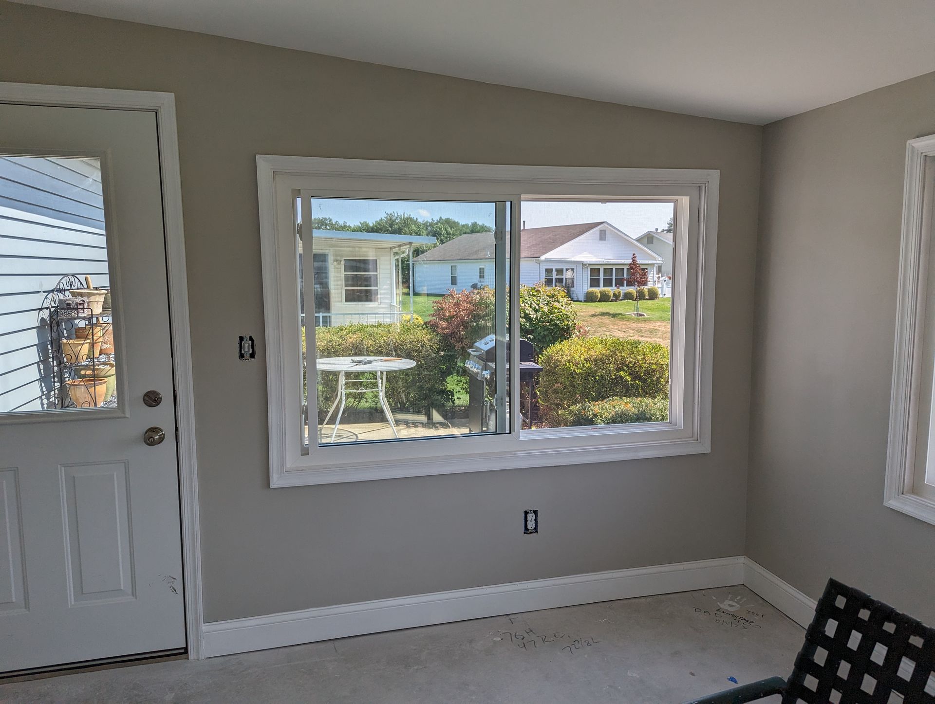 A room with a large window and a door.
