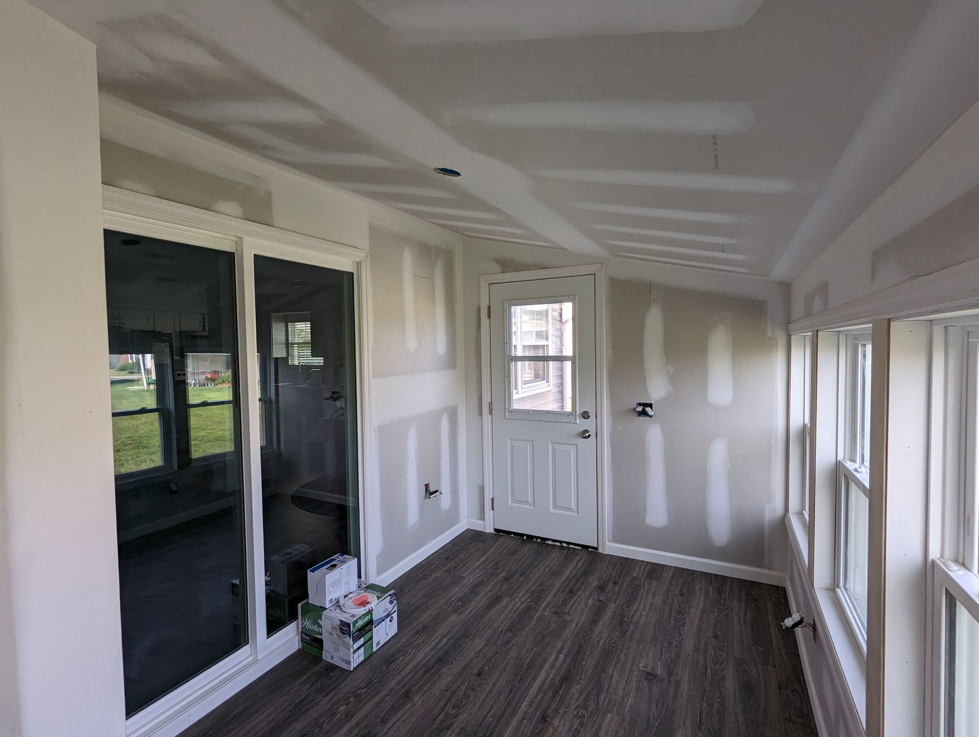 A room with a lot of windows and a door.