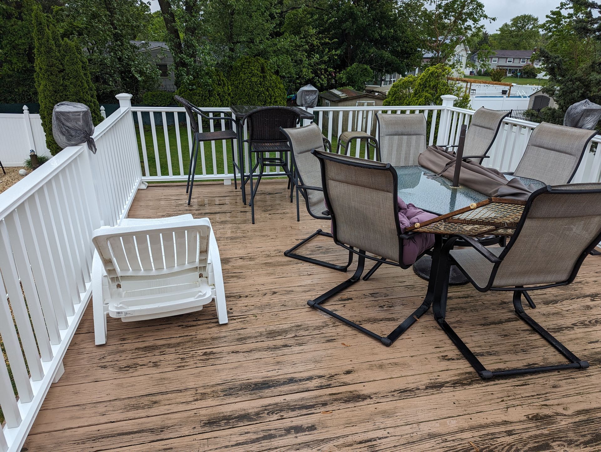 A deck with a table and chairs on it.