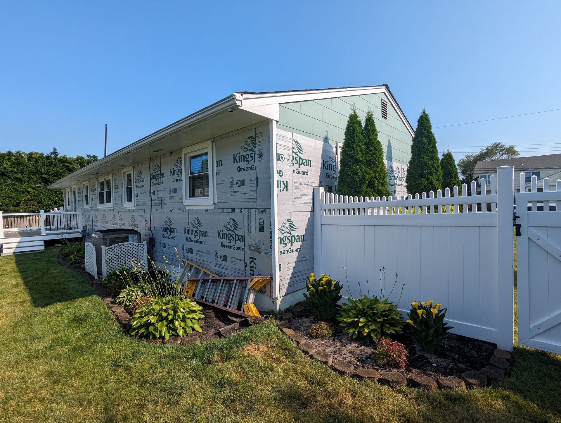A house with a white picket fence in front of it.