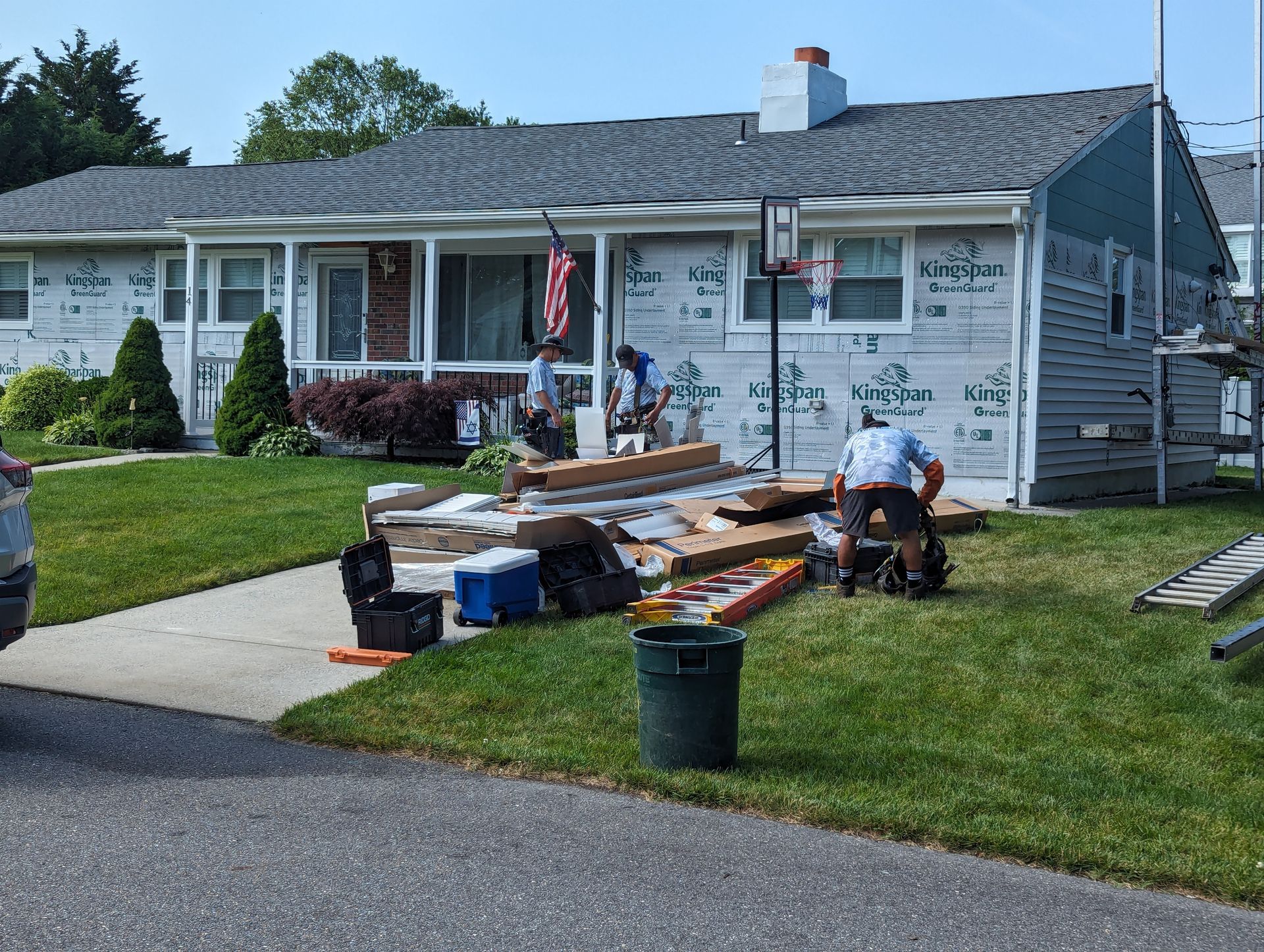 A group of people are working on a house.