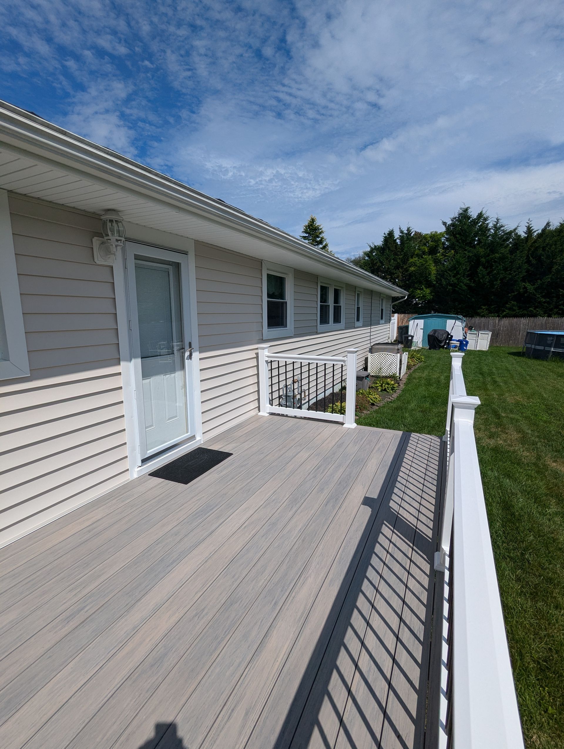 A house with a large deck and a white railing.