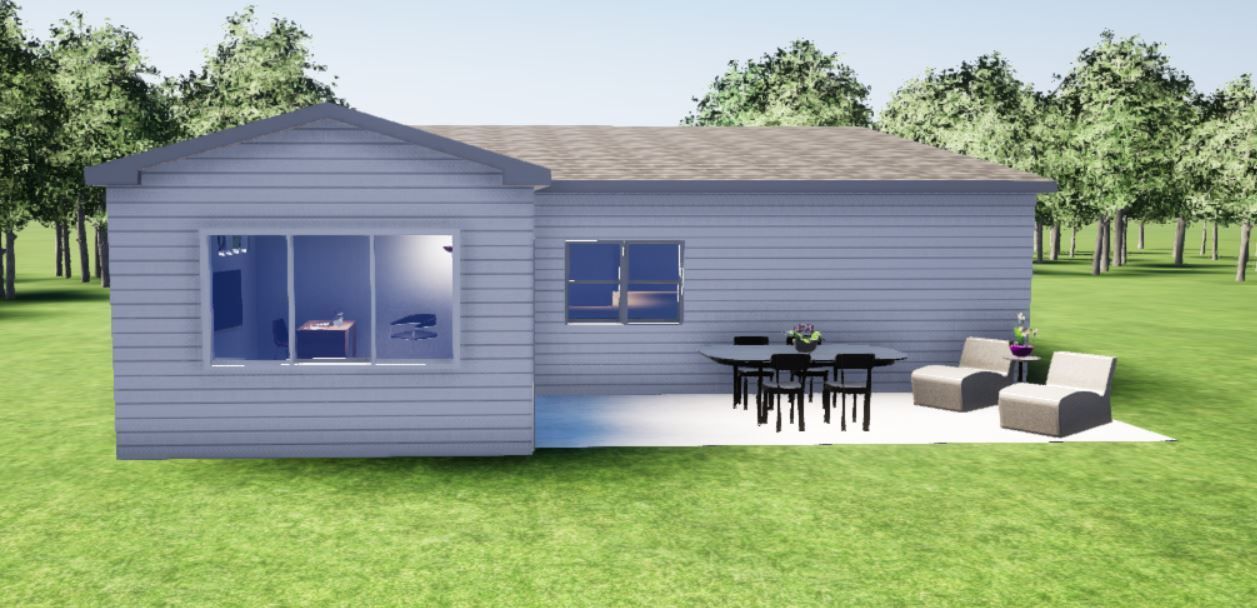 A small house with a patio and a table and chairs in front of it.