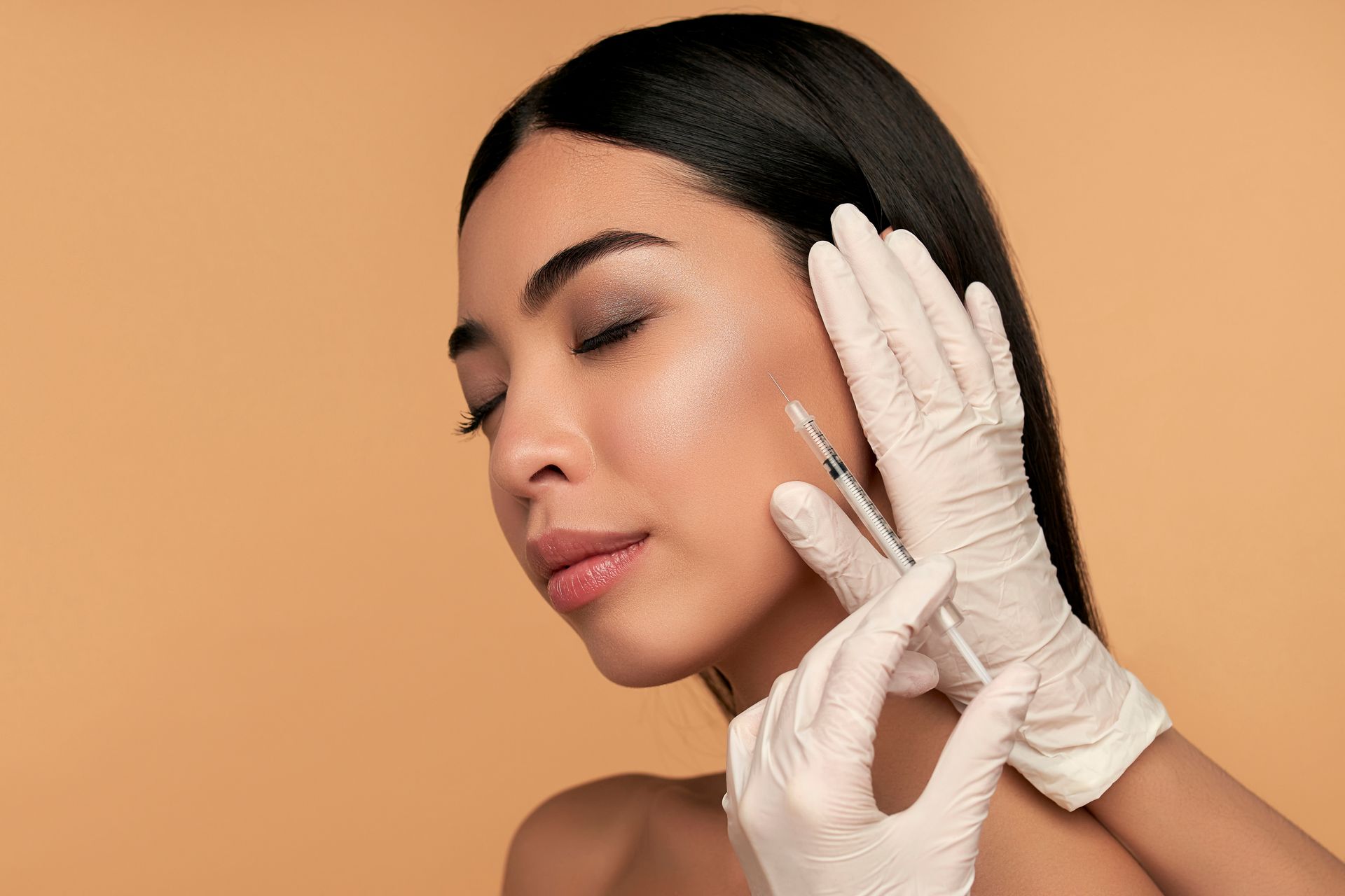 A woman is getting a botox injection in her face.