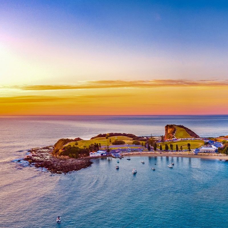 Sunset Over Coastal Town With Boats In Harbor — NLJ Partners P/L In Wyong, NSW