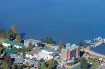 An aerial view of a large body of water surrounded by buildings and trees.