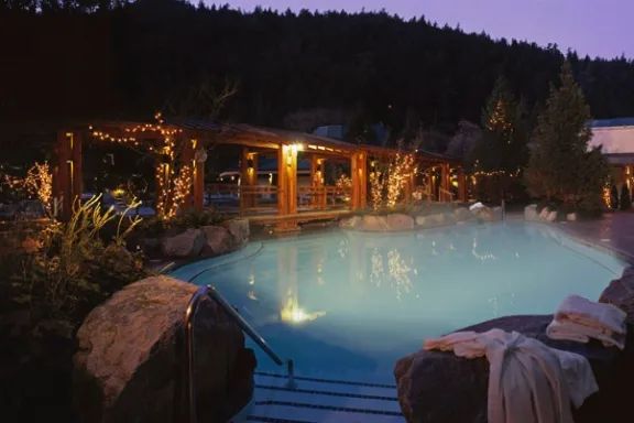 A large swimming pool is lit up at night