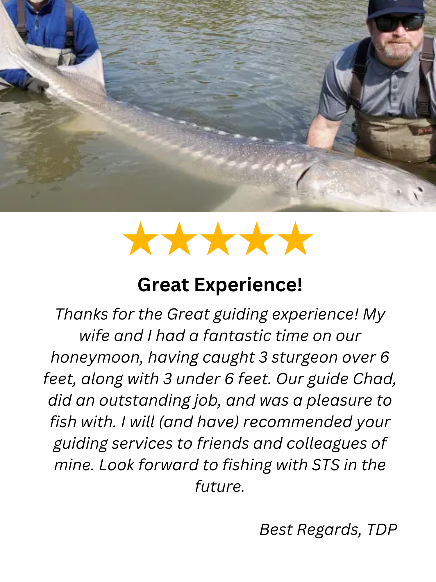 A man is holding a large fish in a river.