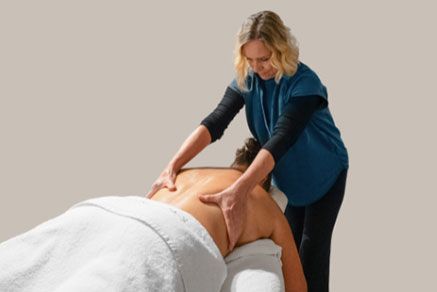 A Massage Therapist Giving a Back Massage to a Client — Aqua Marine Skin and Beauty in Tuncurry, NSW