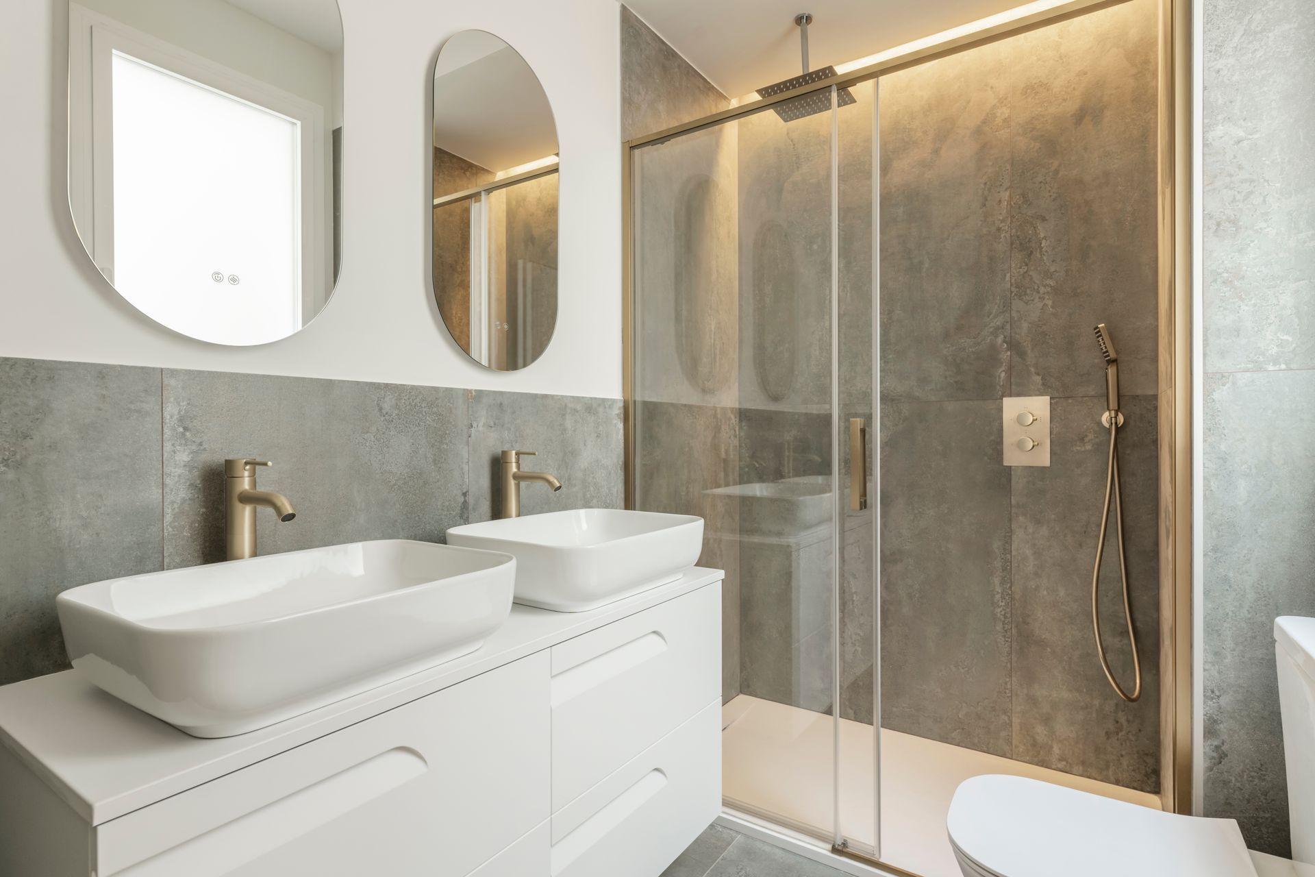 A modern bathroom space with a built-in porcelain sink and a frameless glass shower enclosure.