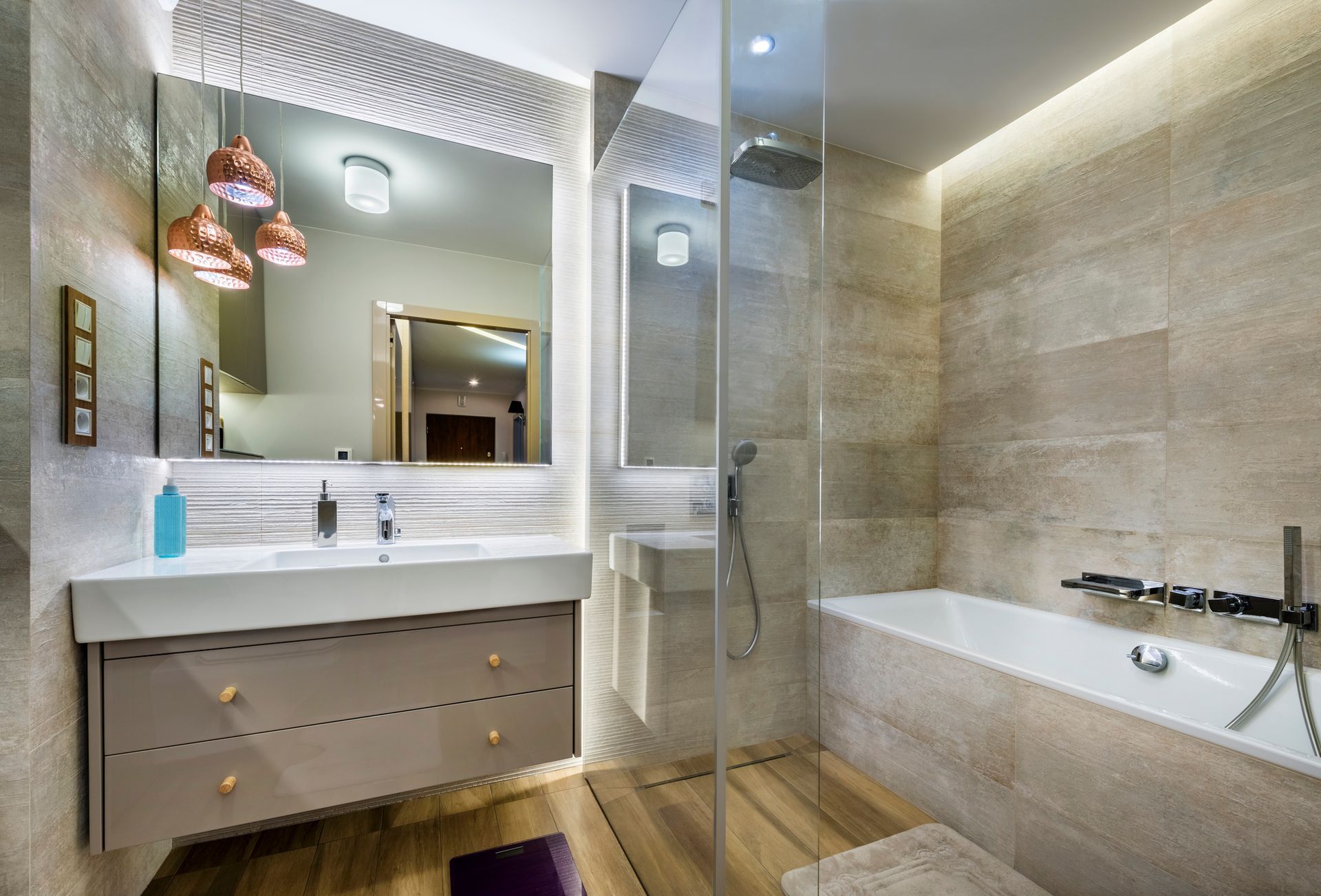 Elegant bathroom with frameless shower doors, modern sink, and clean design for a sleek aesthetic.