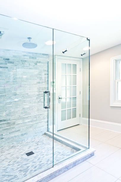 Modern bathroom with frameless shower doors, sleek glass enclosure, and contemporary tile design.