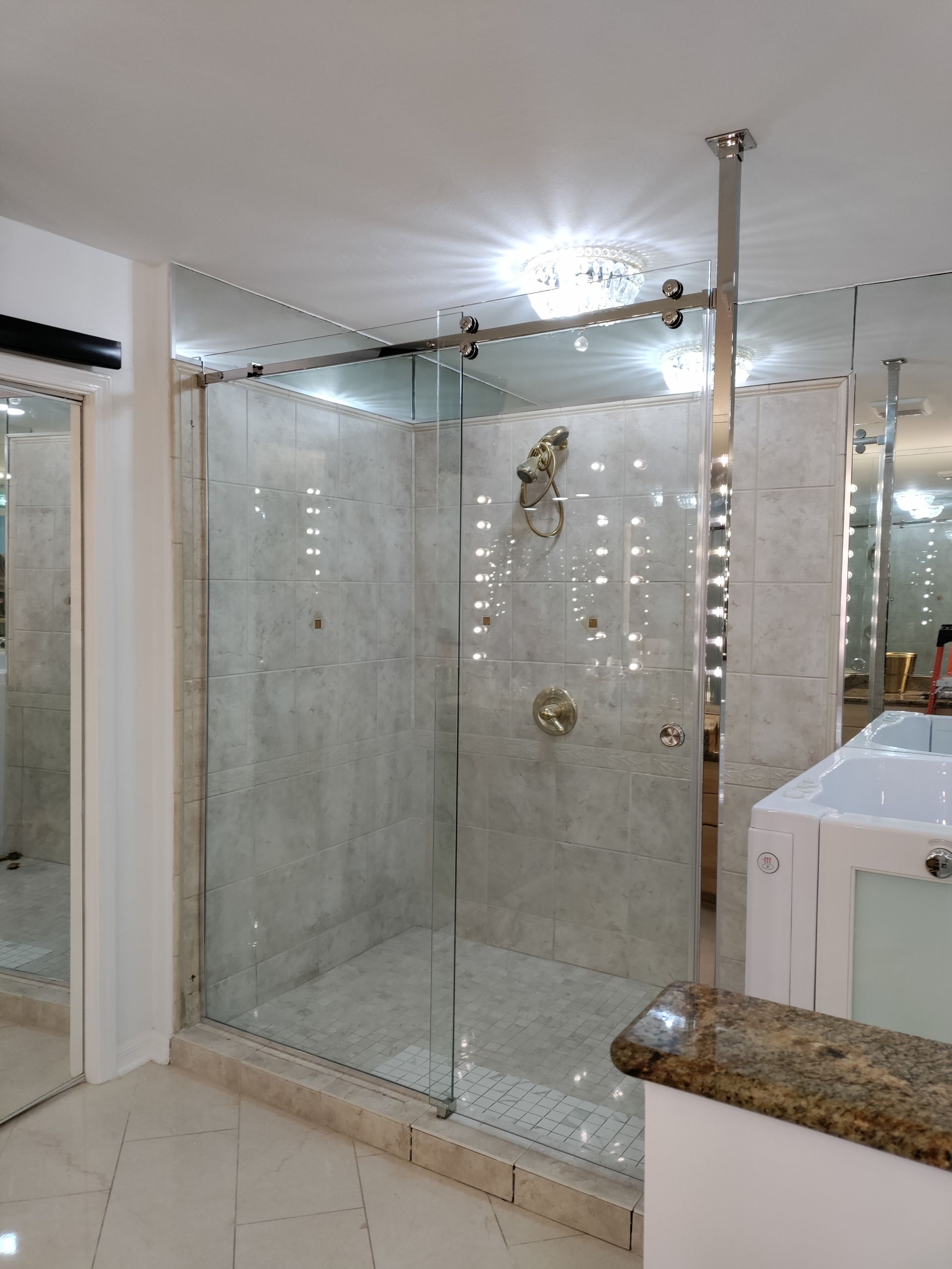 A bathroom with a sliding glass shower door