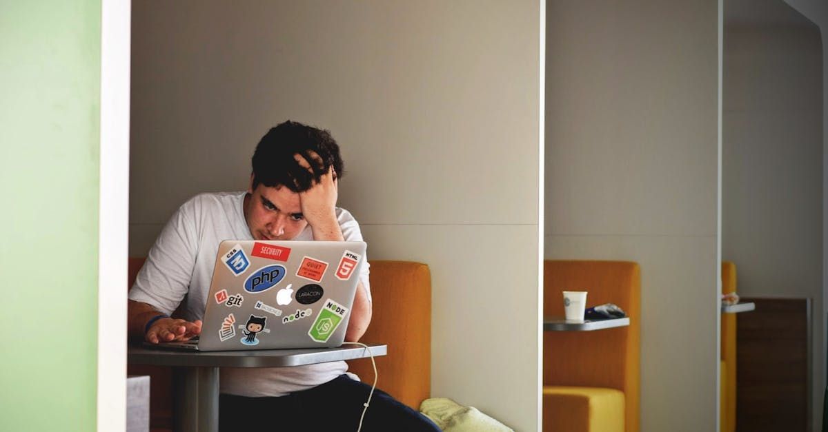 man looking at a laptop with anxiety
